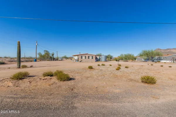 a view of a dry yard with a house