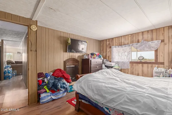 a bed sitting in a bedroom next to a window