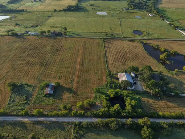 an aerial view of a house with a yard