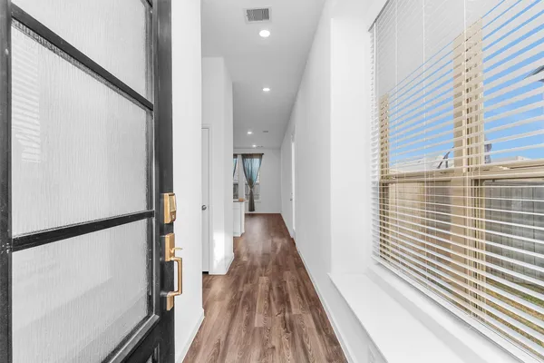 a view of wooden floor and windows in a room