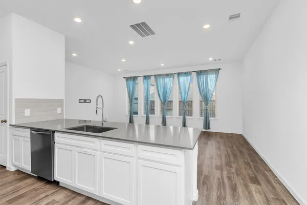 a kitchen with sink a microwave and stove