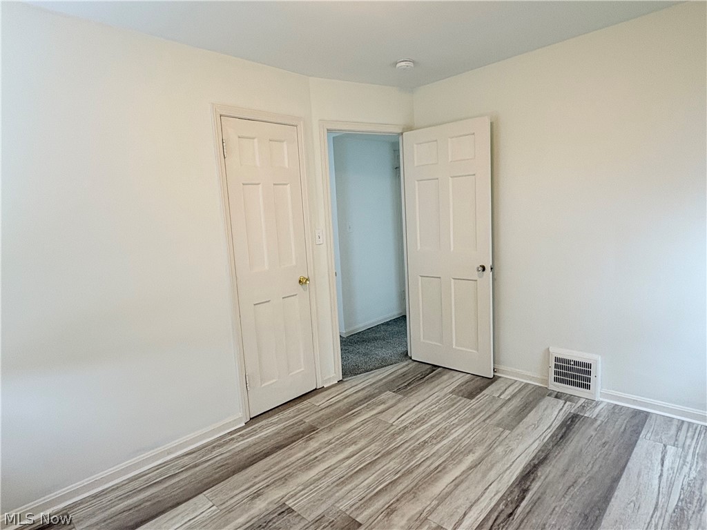 15521 Corkhill Road Maple Heights, OH 44137 - Photo 8 of 33 Unfurnished bedroom with light wood-style floors and baseboards