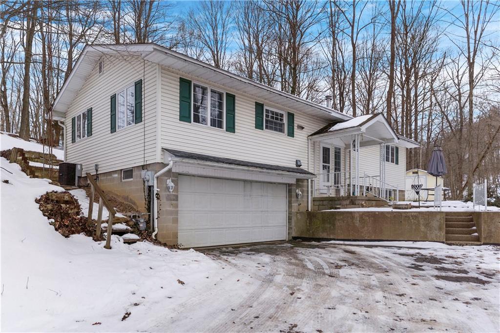 a front view of a house with a yard covered with snow in front of house