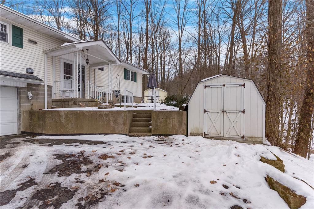 522 Spring Street Jamestown, PA 16134 - Photo 2 of 35 a view of a white house with a yard covered in snow