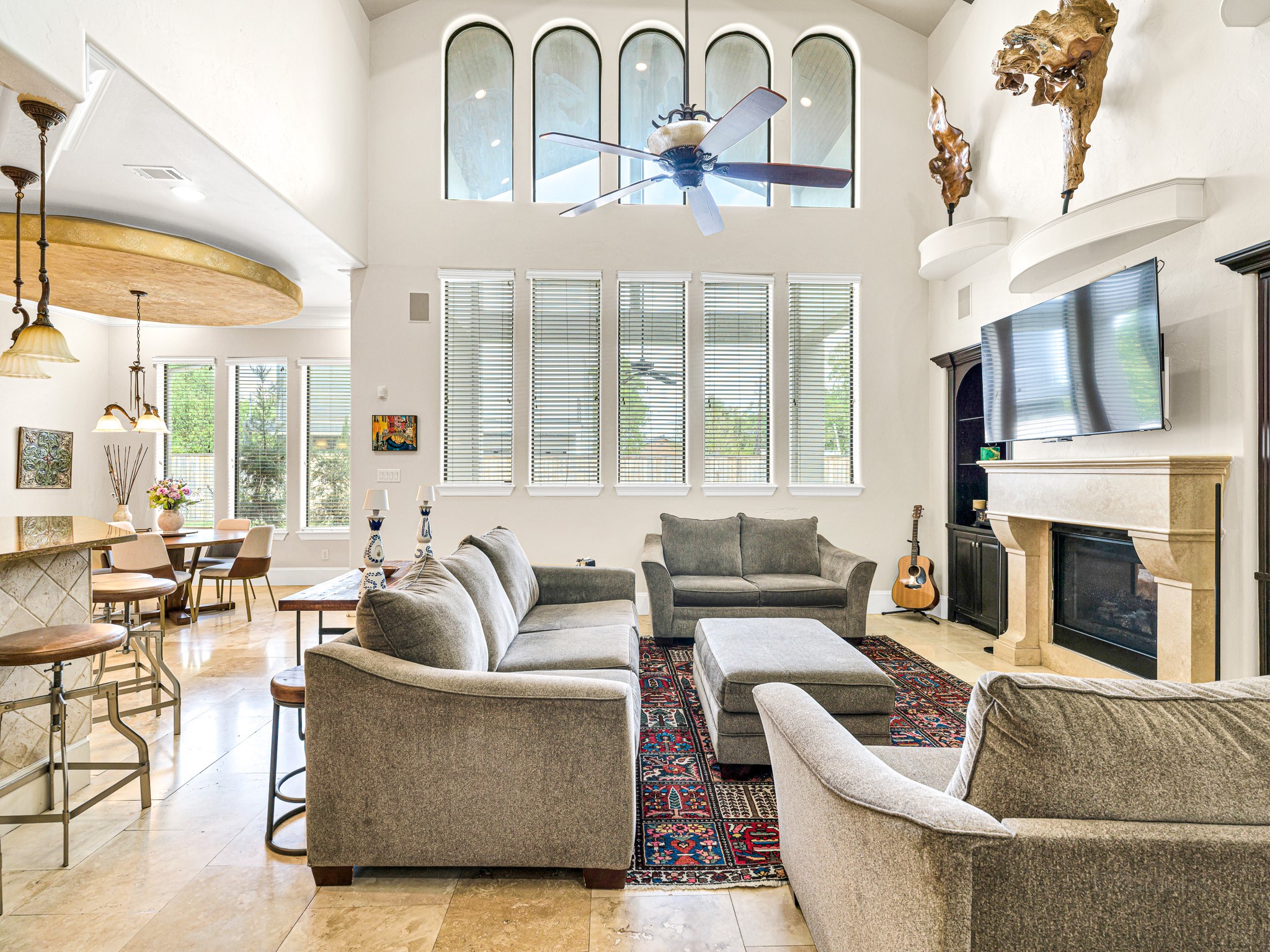 4614 Inker Street Houston, TX 77007 - Photo 11 of 36 This family room features high ceilings and large arched windows. It includes a gas fireplace shared with the formal living room and flows into the kitchen and breakfast area.