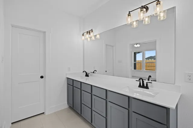 a bathroom with a double vanity sink and mirror