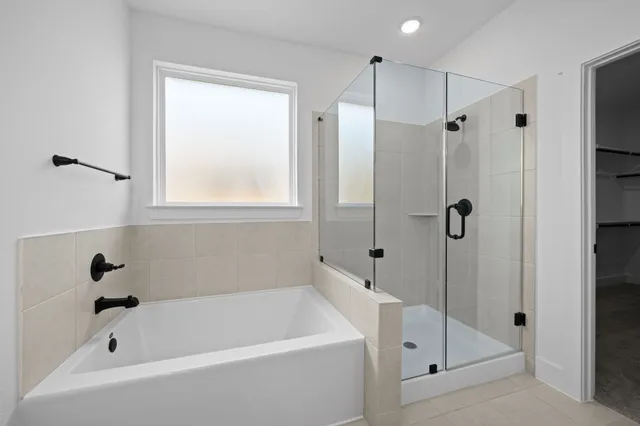 a white bath tub sitting next to a shower