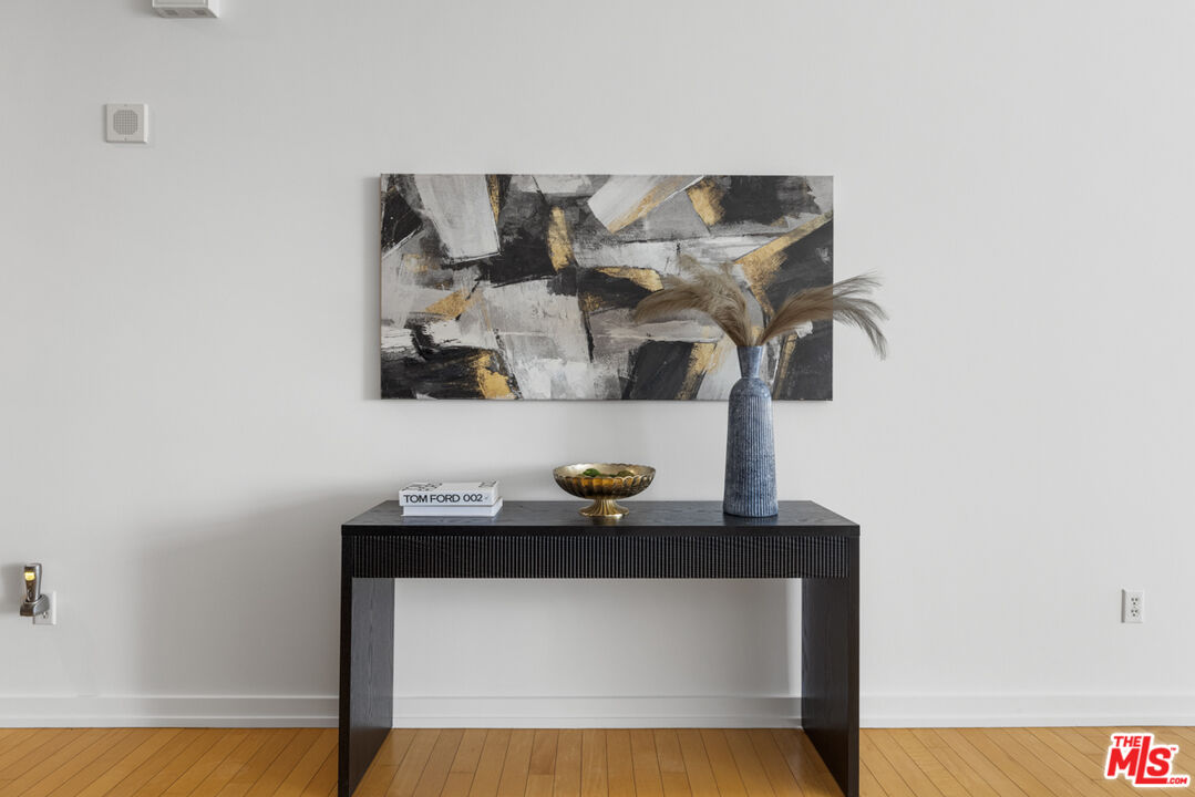 801 South Grand Avenue, Unit 1508 Los Angeles, CA 90017 - Photo 11 of 56 a table with a vase and flowers on it
