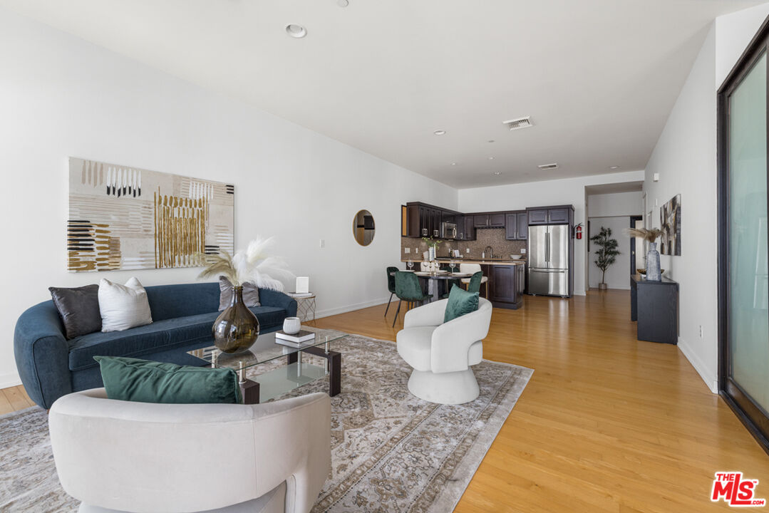 801 South Grand Avenue, Unit 1508 Los Angeles, CA 90017 - Photo 12 of 56 a living room with furniture and wooden floor