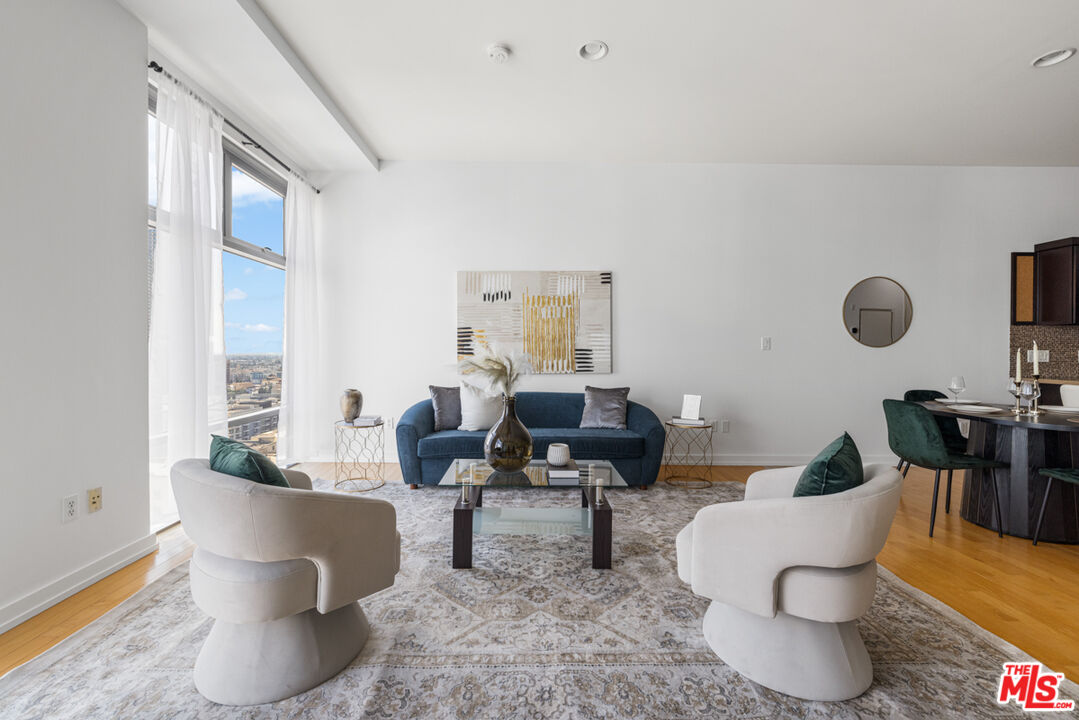 801 South Grand Avenue, Unit 1508 Los Angeles, CA 90017 - Photo 16 of 56 a living room with furniture and a large window