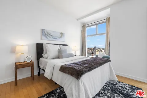 a bedroom with a bed window and walk in closet