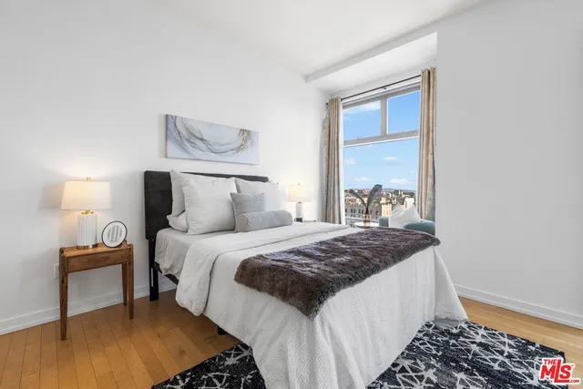 a bedroom with a bed window and walk in closet