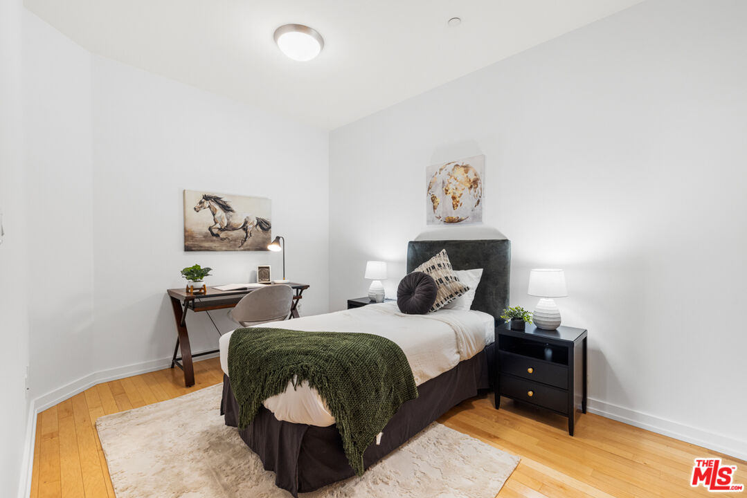 801 South Grand Avenue, Unit 1508 Los Angeles, CA 90017 - Photo 35 of 56 a bedroom with a bed and a table