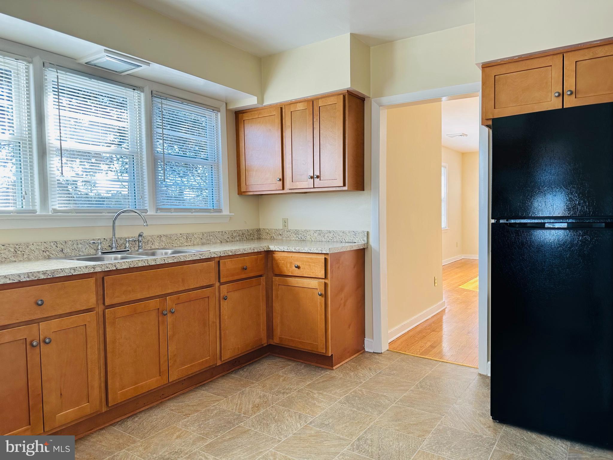 11447 Marsh Road Bealeton, VA 22712 - Photo 3 of 9 a kitchen with stainless steel appliances granite countertop a refrigerator and a sink