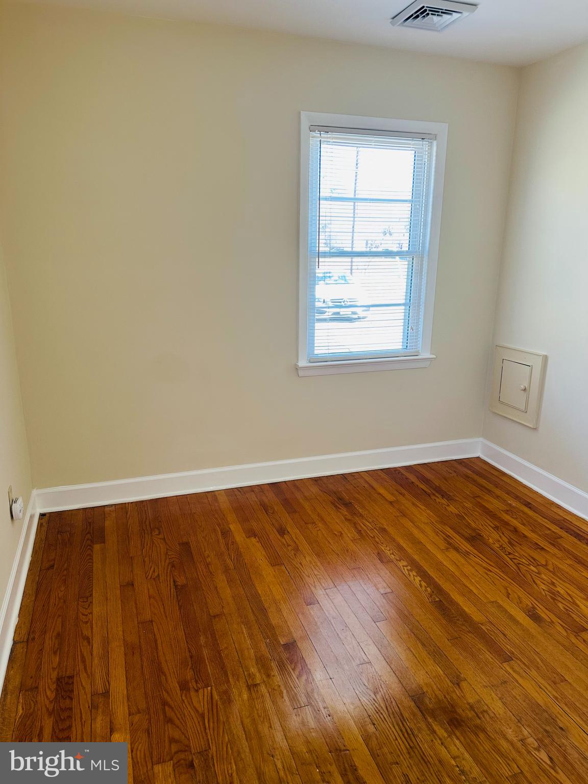 11447 Marsh Road Bealeton, VA 22712 - Photo 5 of 9 an empty room with wooden floor and windows