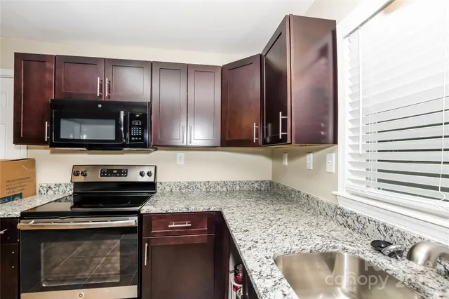 a kitchen with a sink stove and microwave