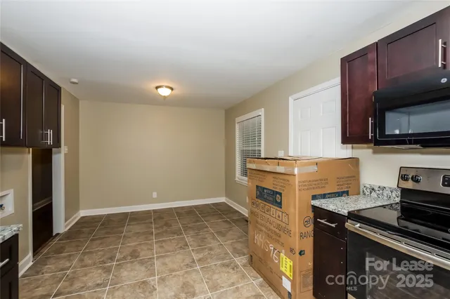 a kitchen with a stove a microwave and a sink
