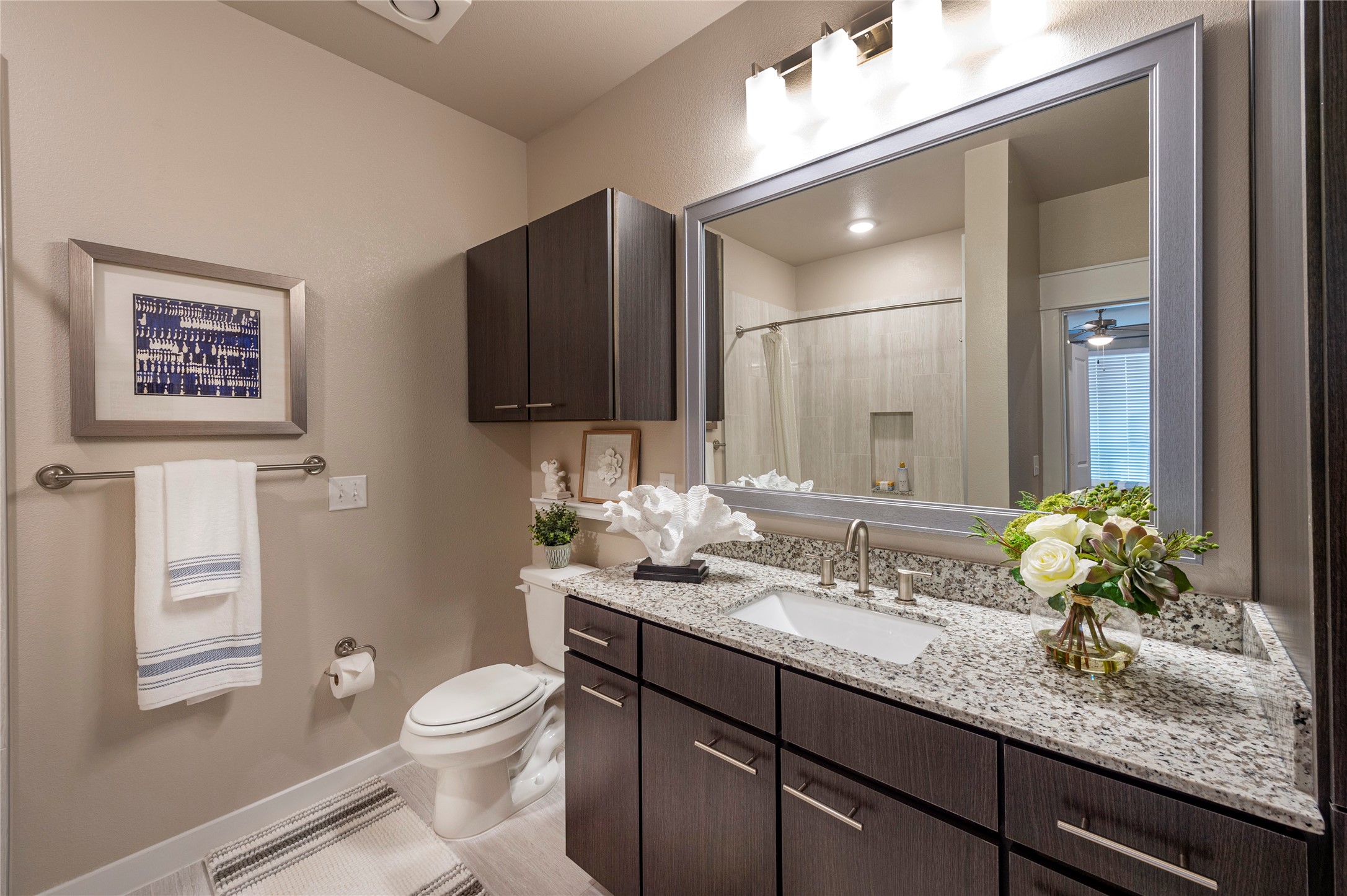 1616 Partnership Way, Unit 2219 Katy, TX 77449 - Photo 16 of 22 a bathroom with a granite countertop sink a toilet and a mirror