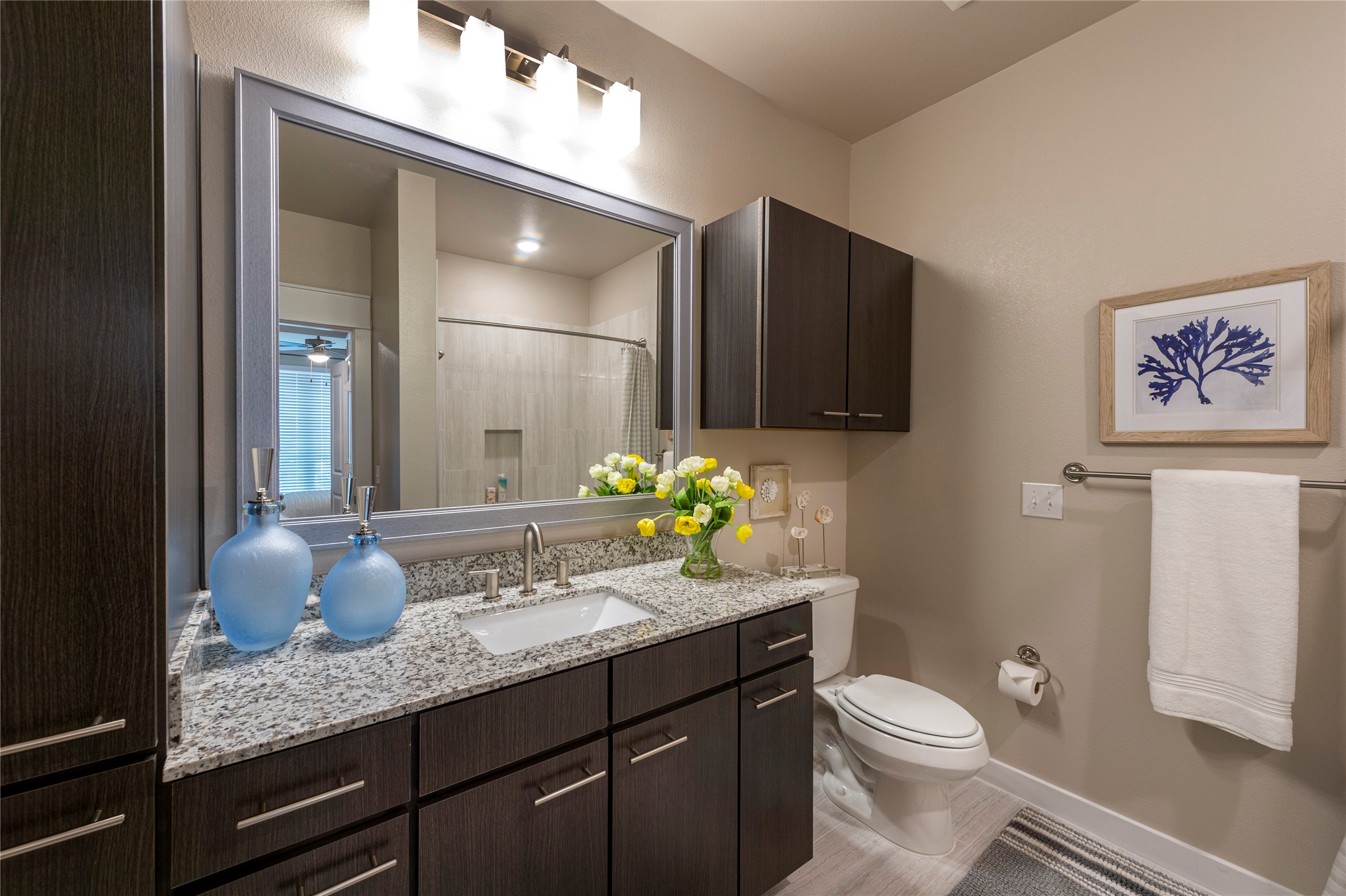 1616 Partnership Way, Unit 2219 Katy, TX 77449 - Photo 19 of 22 a bathroom with a granite countertop sink a toilet and mirror