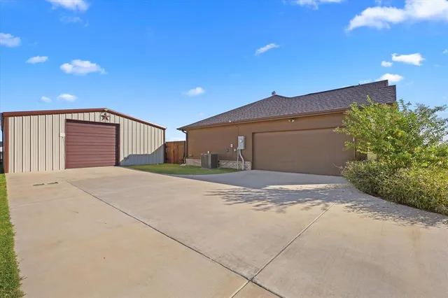 a view of a house with a yard and garage