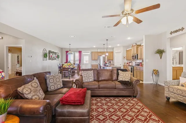 a living room with furniture or couch and a view of kitchen