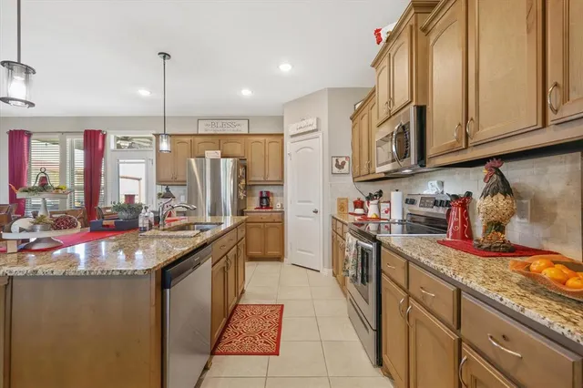 a kitchen with stainless steel appliances granite countertop a sink and cabinets