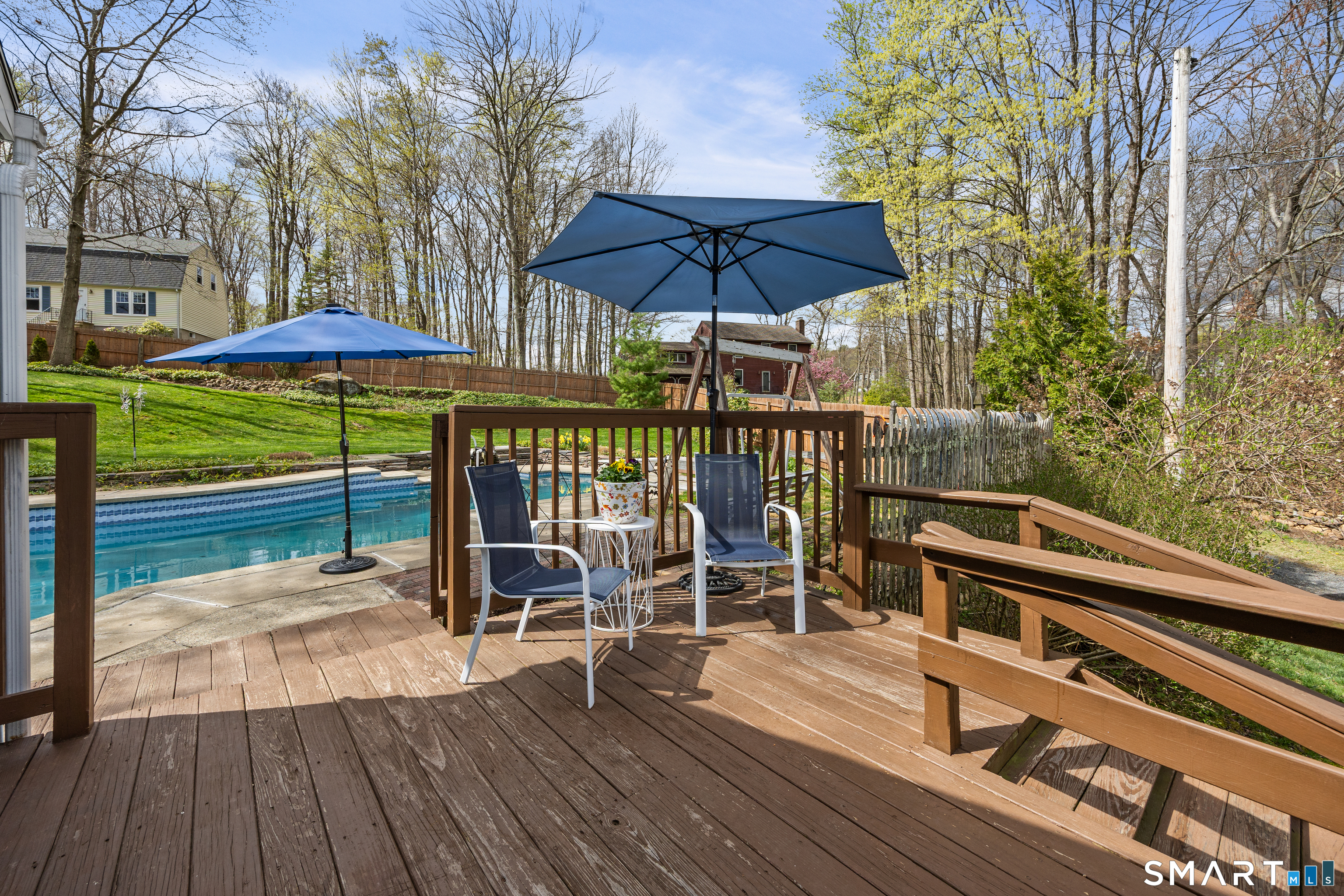 42 Chimney Sweep Road Wallingford, CT 06492 - Photo 9 of 40 a view of a roof deck with table and chairs under an umbrella with wooden floor