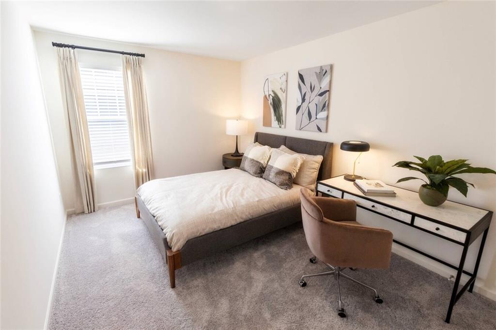 3373 Fence Road Northeast, Unit D4 Dacula, GA 30019 - Photo 17 of 40 a bedroom with a bed and a painting on the wall