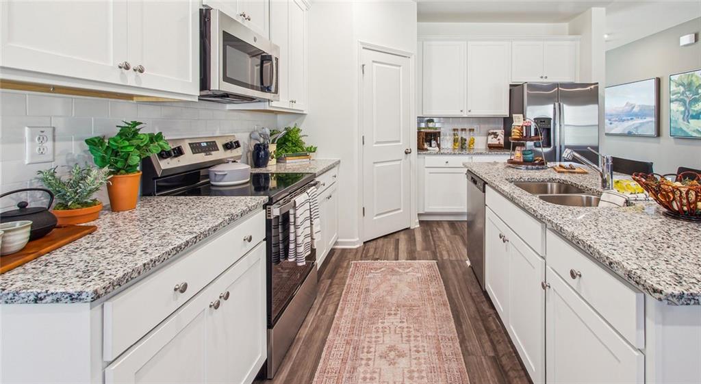 3373 Fence Road Northeast, Unit D4 Dacula, GA 30019 - Photo 21 of 40 a kitchen with granite countertop lots of counter top space