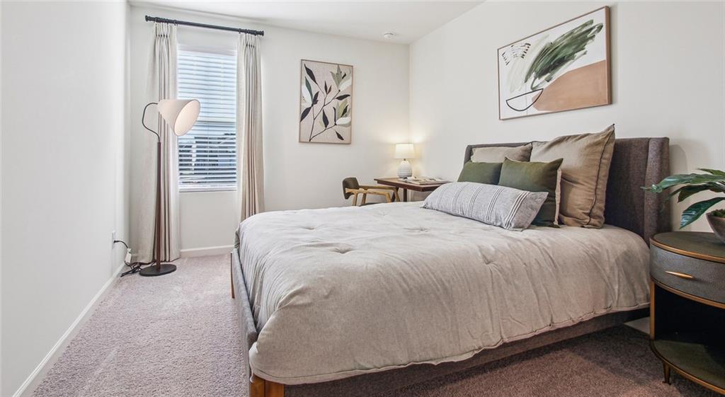 3373 Fence Road Northeast, Unit D4 Dacula, GA 30019 - Photo 31 of 40 a bedroom with a bed and painting on the wall