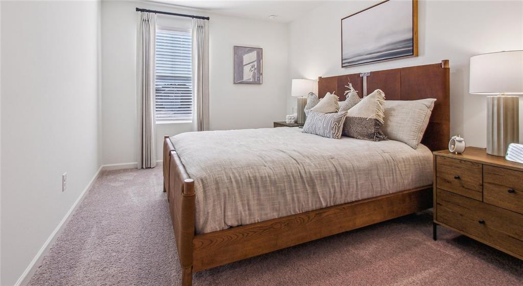 3373 Fence Road Northeast, Unit D4 Dacula, GA 30019 - Photo 33 of 40 a large bed sitting in a bedroom next to a window