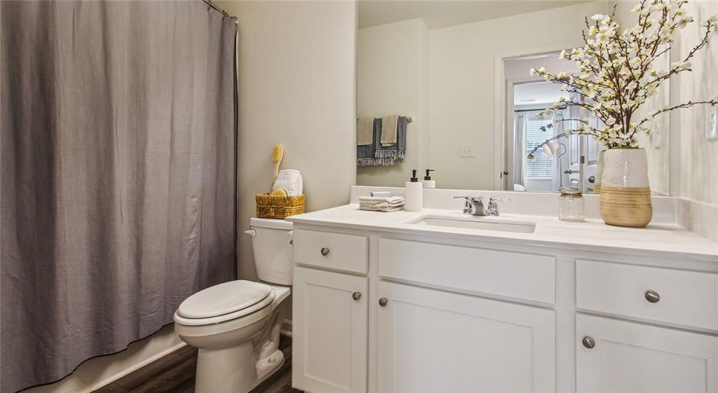 3373 Fence Road Northeast, Unit D4 Dacula, GA 30019 - Photo 35 of 40 a bathroom with a sink a toilet and shower