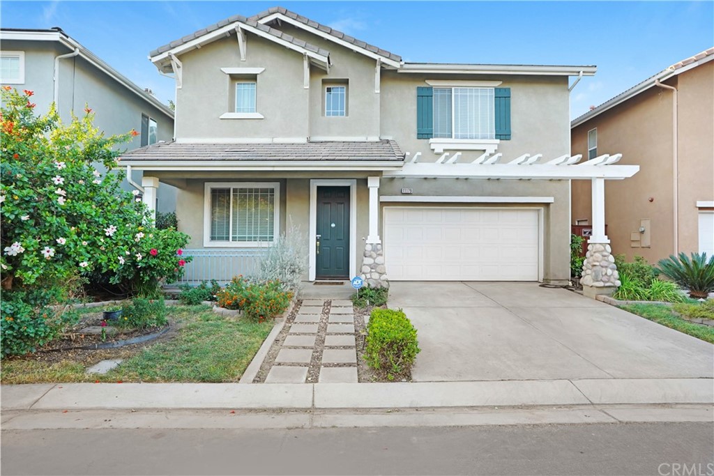 11179 Bridgefield Court Riverside, CA 92505 - Photo 1 of 1 a front view of a house with a garden and garage