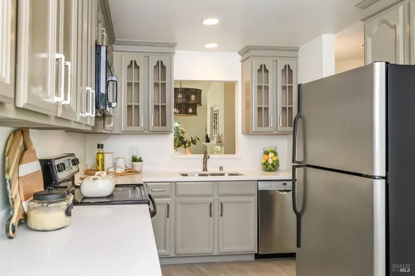 a kitchen with a sink appliances and cabinets