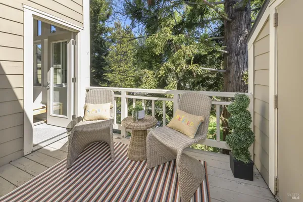 a view of balcony with couch and chairs