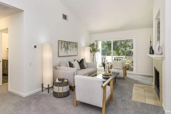 a living room with furniture and a floor to ceiling window