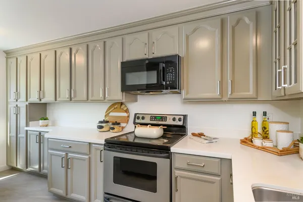 a kitchen with stainless steel appliances granite countertop a stove a microwave and cabinets