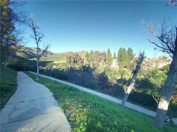 a view of a pathway with a yard