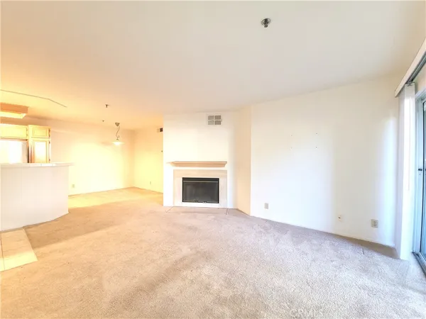 a view of empty room with a fireplace