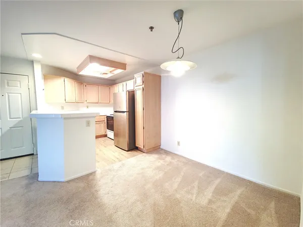 a view of a kitchen with a stove cabinets