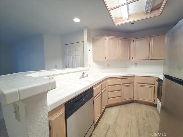 a kitchen with a sink cabinets and window