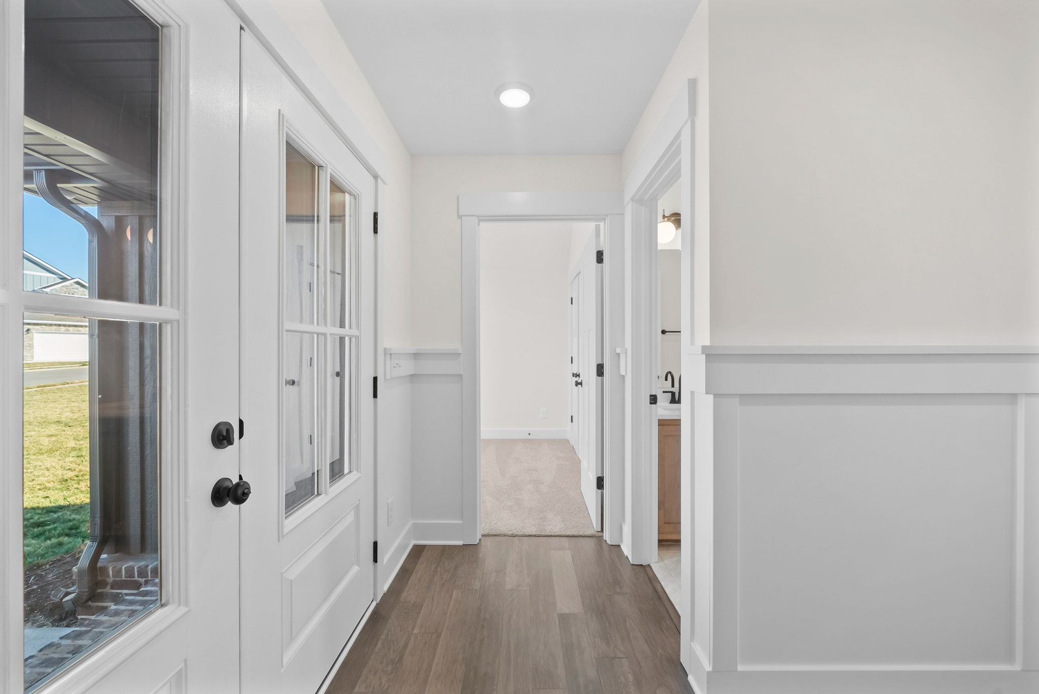 1593 Collins View Way Clarksville, TN 37043 - Photo 26 of 49 a view of a hallway with wooden floor and a bathroom