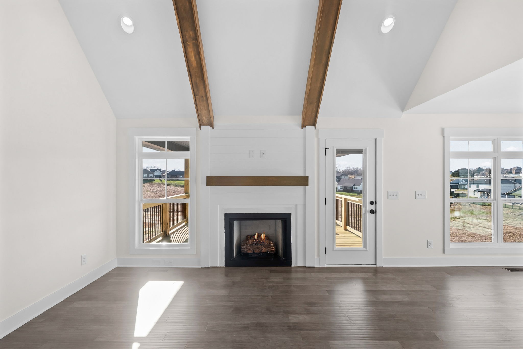 1593 Collins View Way Clarksville, TN 37043 - Photo 6 of 49 an empty room with wooden floor fireplace and windows