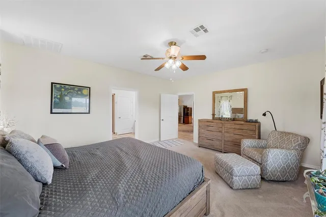 a bedroom with furniture and a large mirror