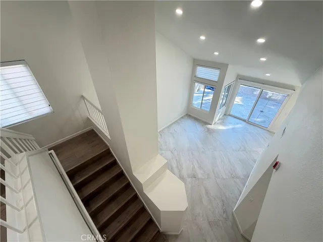 a view of an empty room and wooden floor