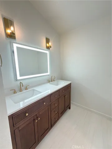 a bathroom with a double vanity sink and a mirror