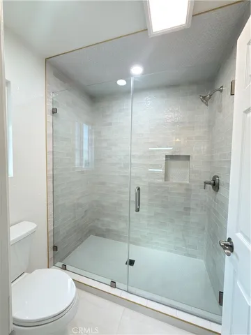 a bathroom with a shower and a toilet