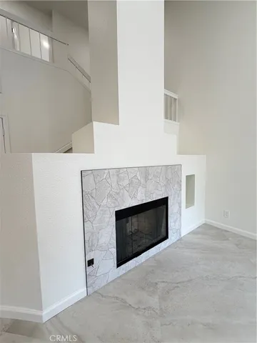 a living room with a fireplace and a fireplace