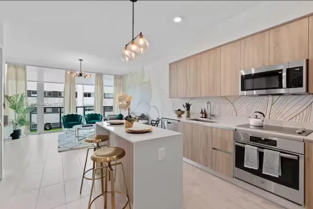a kitchen with a sink stove and microwave