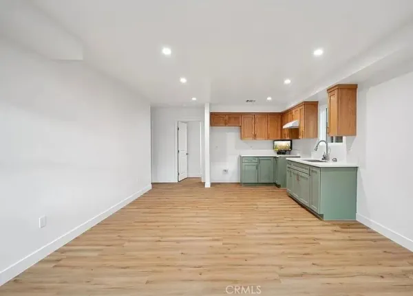 a view of a kitchen with a sink and a refrigerator